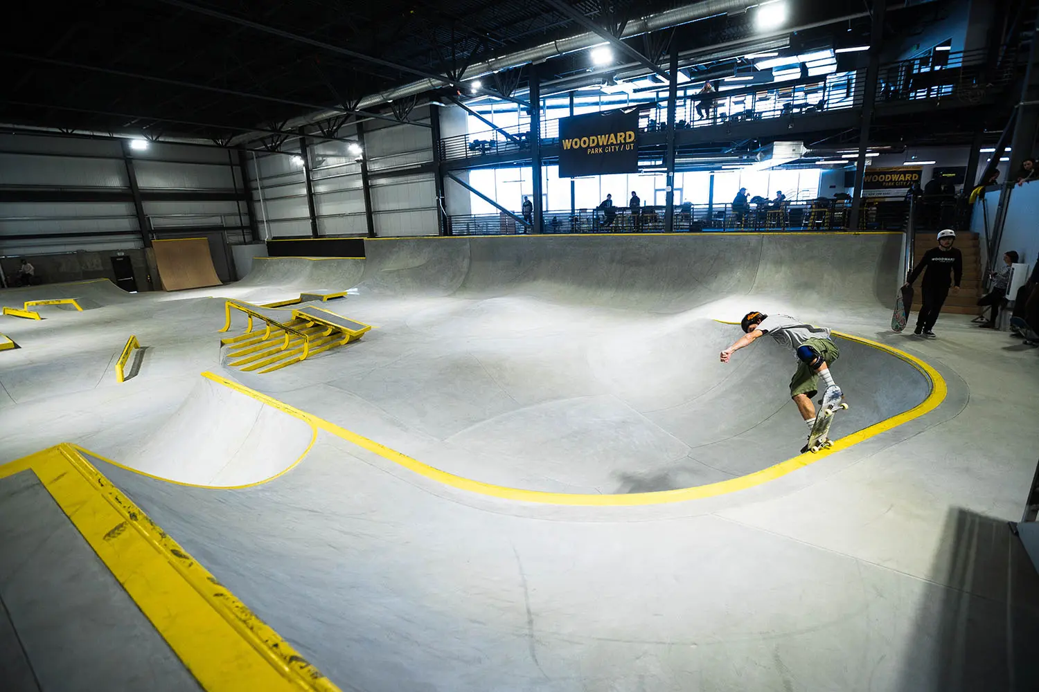 Skater doing a blunt stall in the concrete skatepark
